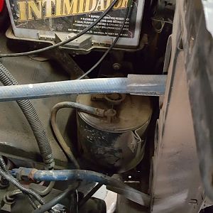 Charcoal canister & steering return lines in way of wider radiator