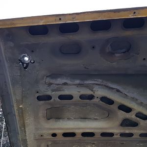 Hacked up hole for hood pin passenger side