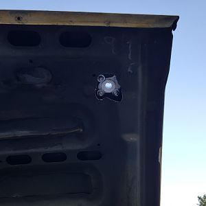 Hacked up hole for hood pin driver side