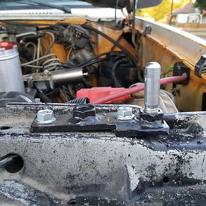 Hood pin bracket driver side