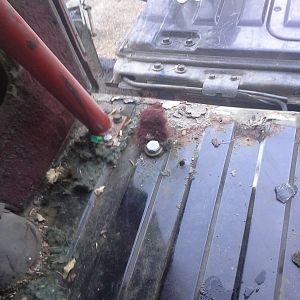 By the fuel filler relief