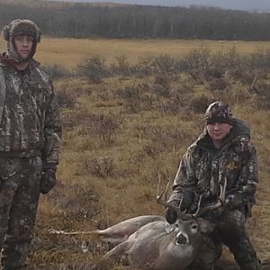 my 2 boys with a White Tail Buck for my youngest boy Tanner. Called him right in to 35 yards