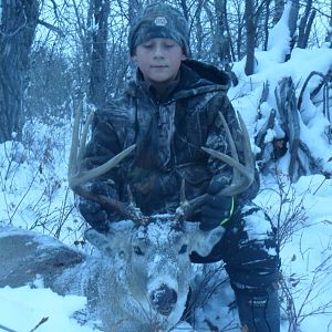my boy mitchel with his 565 yard shot white tail... makes up for his earlier buck that was claimed by a grizzly before we could get to it.