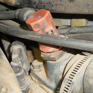 Orange component on top of thermostat housing.