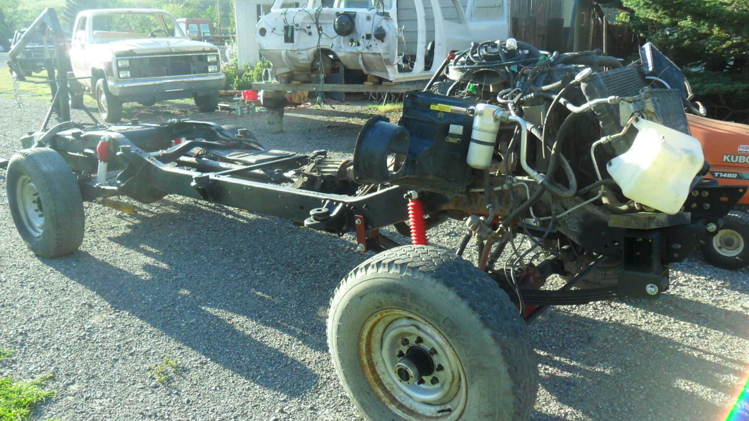 I built a front crossmember with rad support mount and extended spring hangars for the 52" springs I used up front