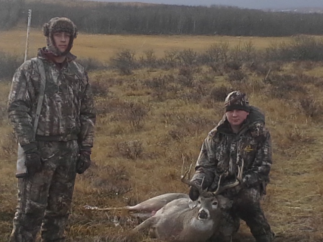 my 2 boys with a White Tail Buck for my youngest boy Tanner. Called him right in to 35 yards