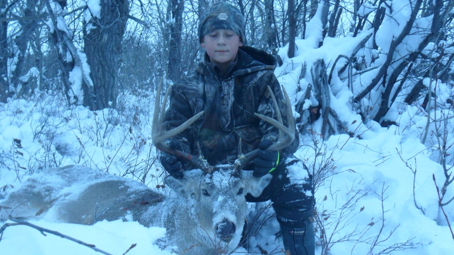 my boy mitchel with his 565 yard shot white tail... makes up for his earlier buck that was claimed by a grizzly before we could get to it.