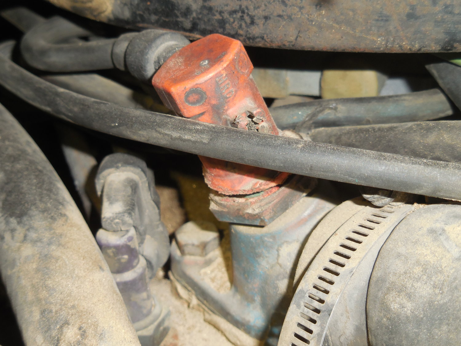 Orange component on top of thermostat housing.