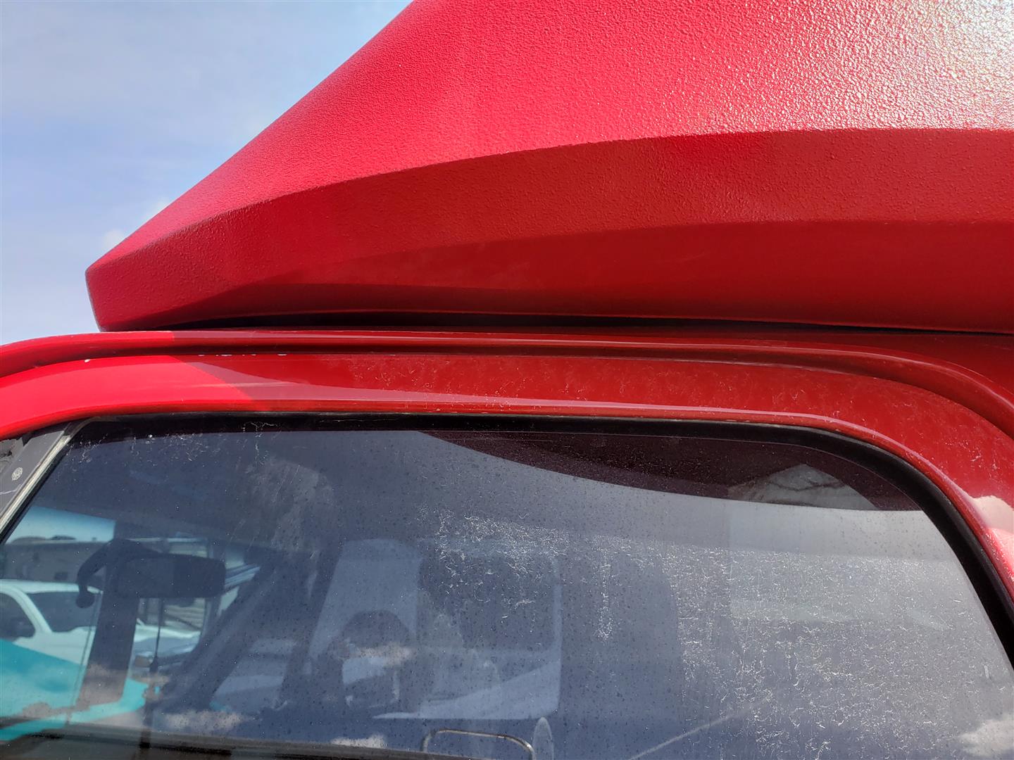 Top resting on cab roof.